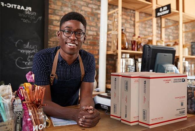 Small Business owner preparing to ship Priority Mail packages.